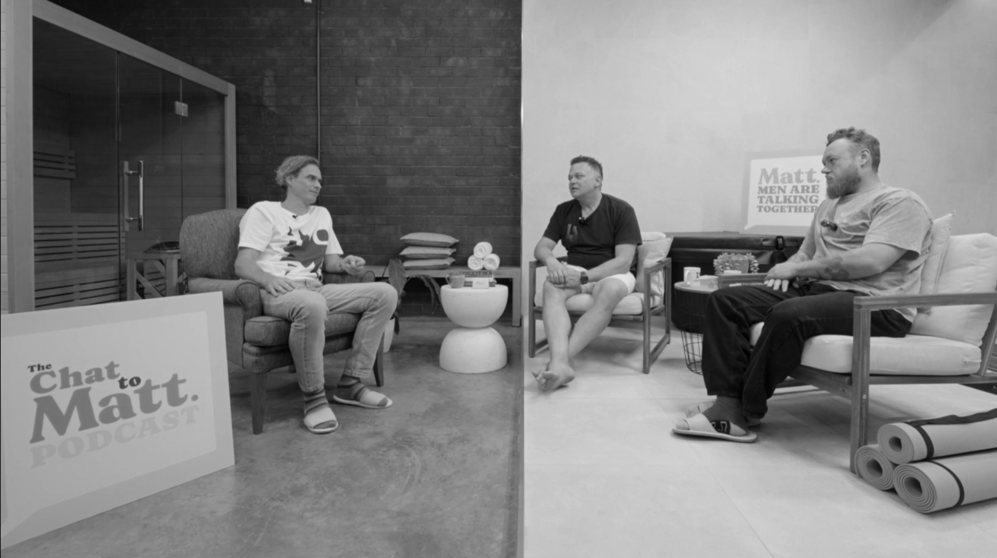 Matt talking with two guests on the Chat to Matt podcast set, beside the sauna